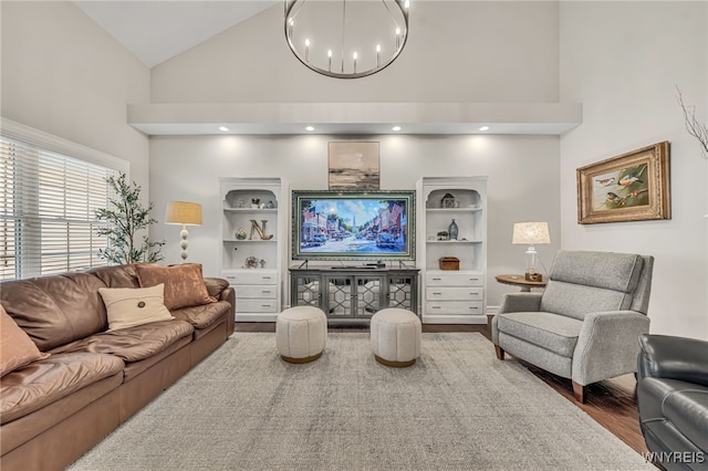 9443 Heritage Path Unit B, Clarence, NY 14032 - living room featuring high vaulted ceiling, wood finished floors, and a chandelier