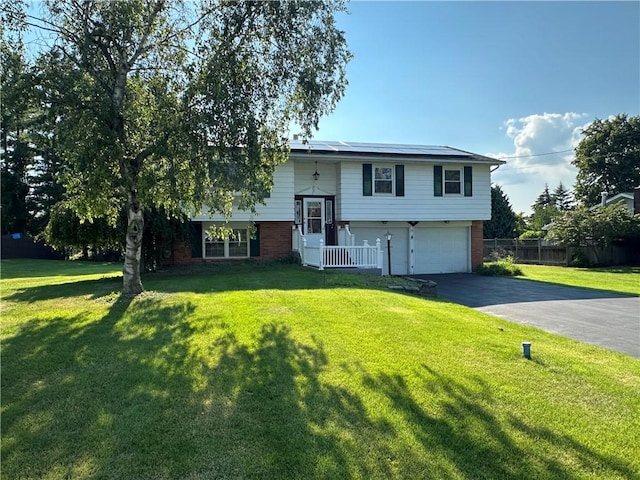 55 Wegman St, Sennett, NY 13021 - bi-level home with driveway, brick siding, roof mounted solar panels, and a garage