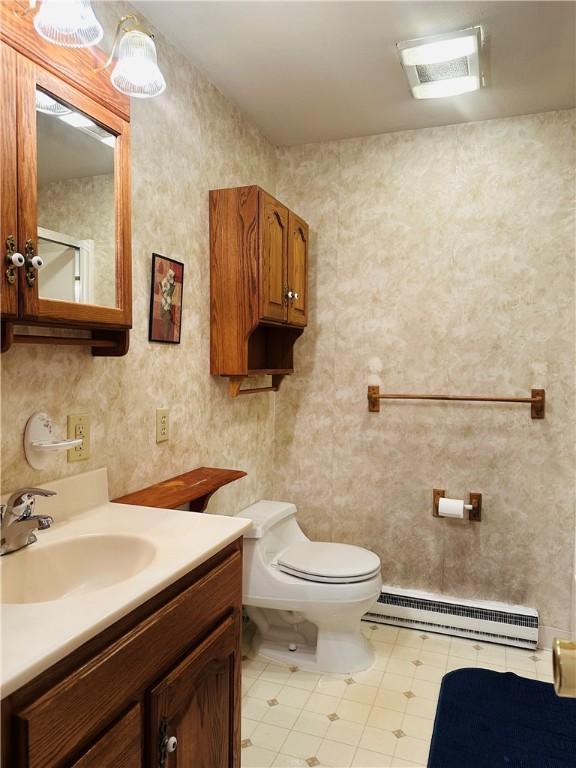 55 Wegman St, Sennett, NY 13021 - bathroom featuring a baseboard heating unit, vanity, and tile patterned floors