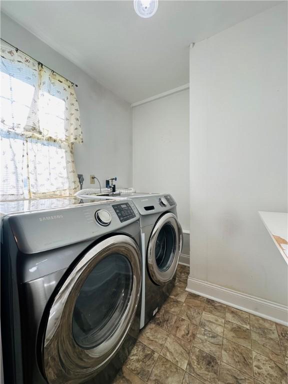 55 Wegman St, Sennett, NY 13021 - laundry room with washing machine and clothes dryer and stone finish floors