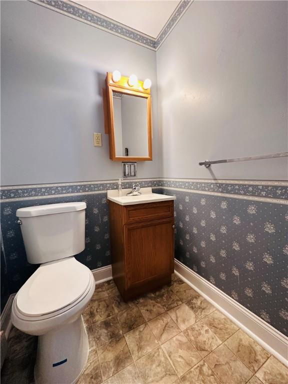 55 Wegman St, Sennett, NY 13021 - half bath featuring vanity, wainscoting, and wallpapered walls