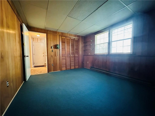 55 Wegman St, Sennett, NY 13021 - carpeted spare room featuring wooden walls and baseboard heating