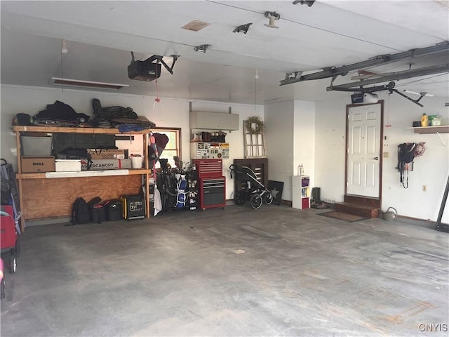115 Meaney Cir, Scriba, NY 13126 - garage featuring a workshop area and a garage door opener