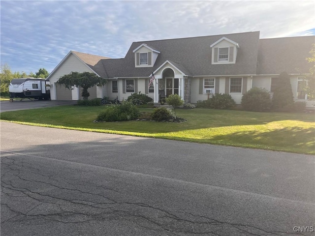 115 Meaney Cir, Scriba, NY 13126 - cape cod house with asphalt driveway, an attached garage, and a front lawn