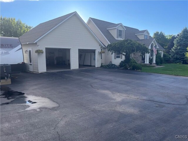 115 Meaney Cir, Scriba, NY 13126 - view of front of home featuring asphalt driveway, an attached garage, and roof with shingles
