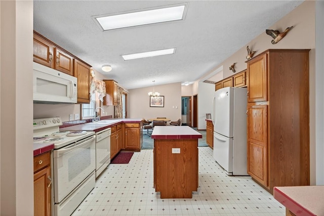 7219 Apple St, Bath, NY 14810 - kitchen with white appliances, a peninsula, a chandelier, vaulted ceiling, and brown cabinetry