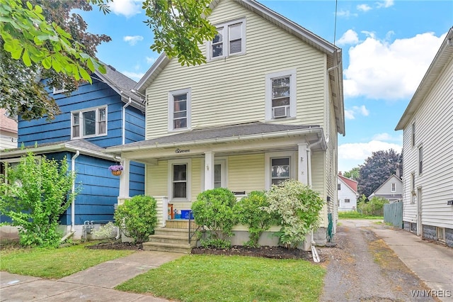 11 7th Ave, North Tonawanda, NY 14120 - view of front facade with a porch, asphalt driveway, and a front yard