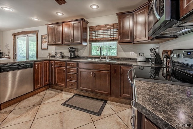283 Erin Rd, Ridgeway, NY 14103 - kitchen with appliances with stainless steel finishes, dark countertops, dark brown cabinets, light tile patterned floors, and recessed lighting