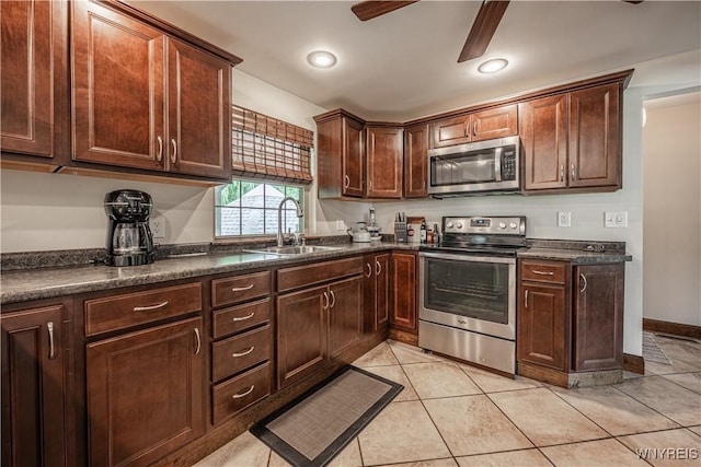 283 Erin Rd, Ridgeway, NY 14103 - kitchen with appliances with stainless steel finishes, dark countertops, a ceiling fan, and light tile patterned floors