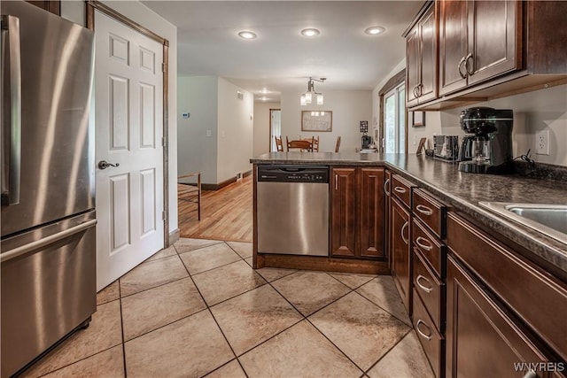 283 Erin Rd, Ridgeway, NY 14103 - kitchen featuring appliances with stainless steel finishes, dark countertops, dark brown cabinets, a peninsula, and recessed lighting