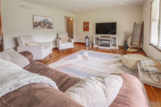 283 Erin Rd, Ridgeway, NY 14103 - living room featuring wood finished floors, recessed lighting, and a glass covered fireplace