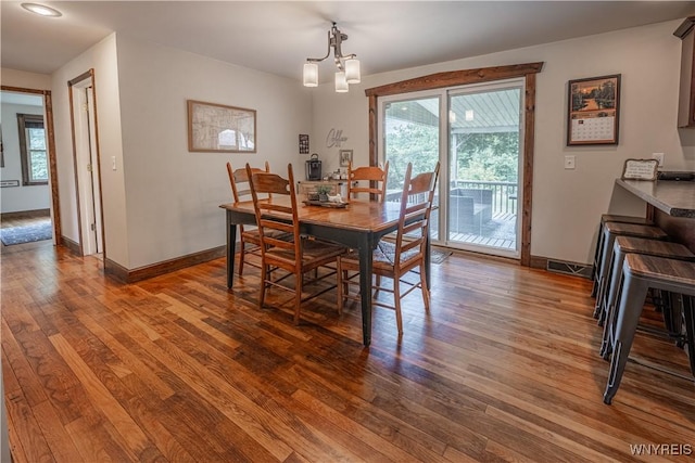 283 Erin Rd, Ridgeway, NY 14103 - dining space with dark wood finished floors and a chandelier