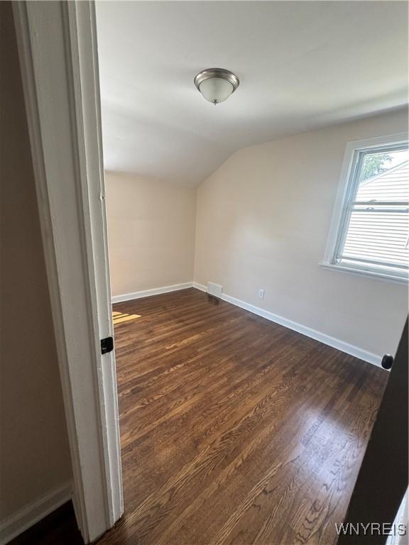 129 Brookside Dr, West Seneca, NY 14220 - unfurnished room with vaulted ceiling and dark wood-style floors