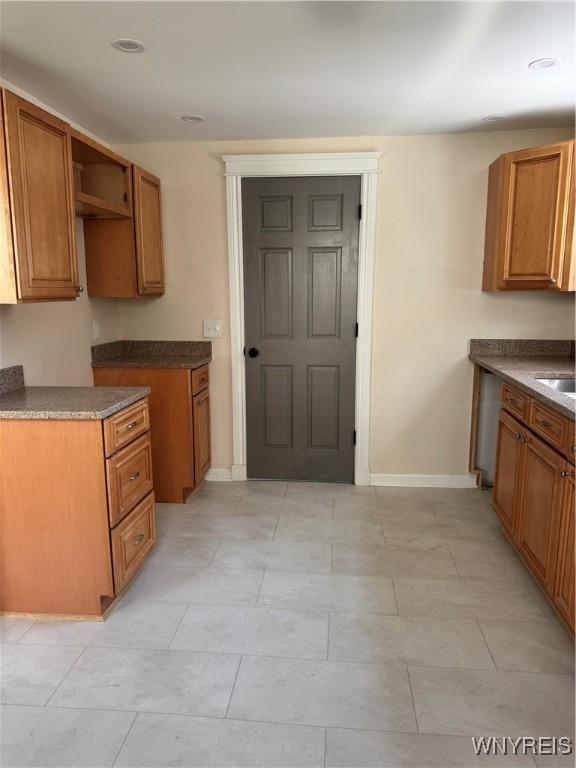 129 Brookside Dr, West Seneca, NY 14220 - kitchen featuring brown cabinetry, dark countertops, and open shelves