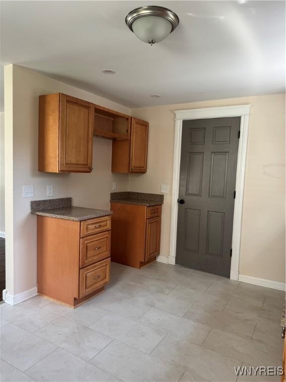 129 Brookside Dr, West Seneca, NY 14220 - kitchen with brown cabinets and dark countertops
