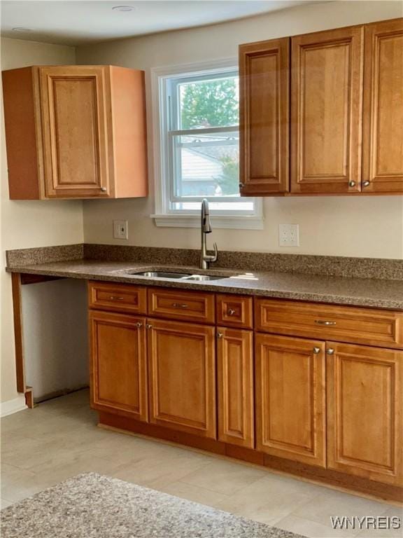 129 Brookside Dr, West Seneca, NY 14220 - kitchen with brown cabinetry and dark countertops