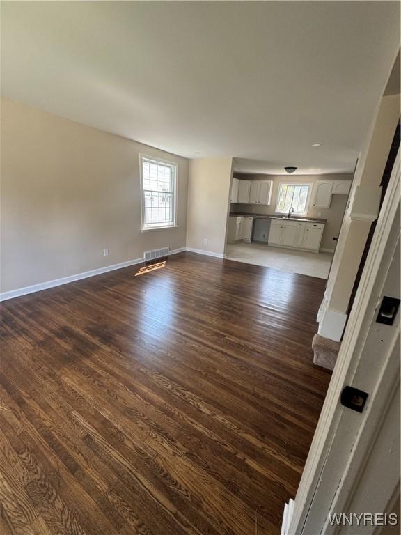 129 Brookside Dr, West Seneca, NY 14220 - unfurnished living room with dark wood finished floors and healthy amount of natural light
