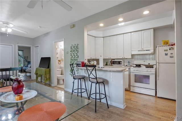 101 Comstock Ave, Syracuse, NY 13210 - kitchen featuring white appliances, under cabinet range hood, ceiling fan, white cabinetry, and recessed lighting