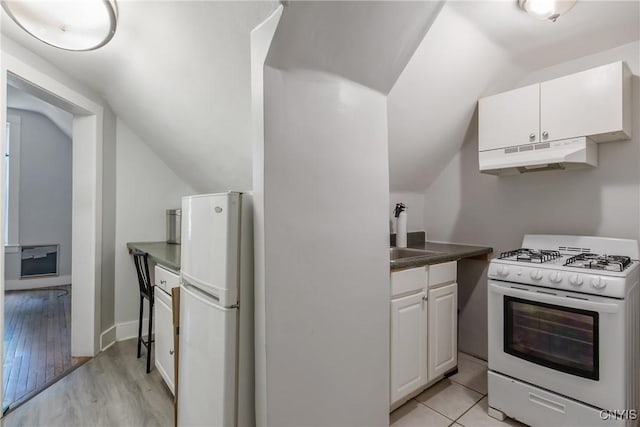 101 Comstock Ave, Syracuse, NY 13210 - kitchen featuring white appliances, under cabinet range hood, lofted ceiling, white cabinetry, and dark countertops