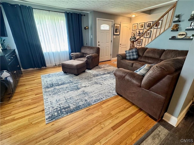 119 Marnie St, Deerfield, NY 13502 - living room featuring stairway, wood finished floors, and a textured ceiling