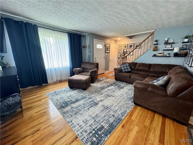 119 Marnie St, Deerfield, NY 13502 - living area featuring stairs, a textured ceiling, and wood finished floors