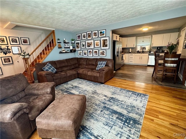 119 Marnie St, Deerfield, NY 13502 - living room with wood finished floors, stairs, and a textured ceiling