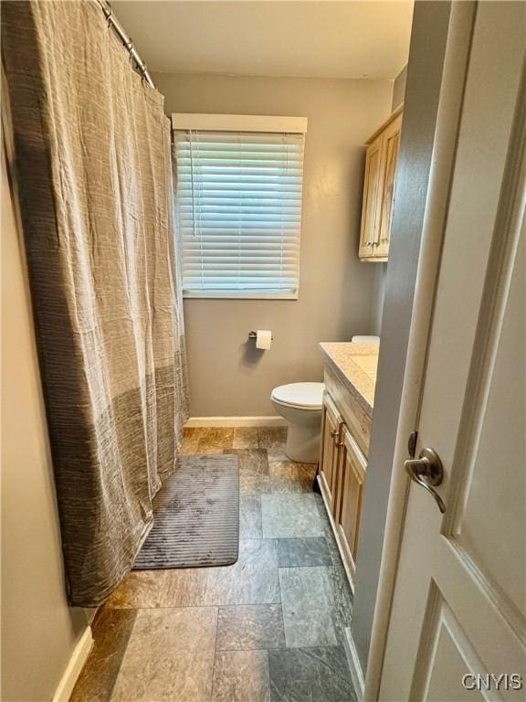 119 Marnie St, Deerfield, NY 13502 - bathroom featuring vanity, stone finish floors, and curtained shower