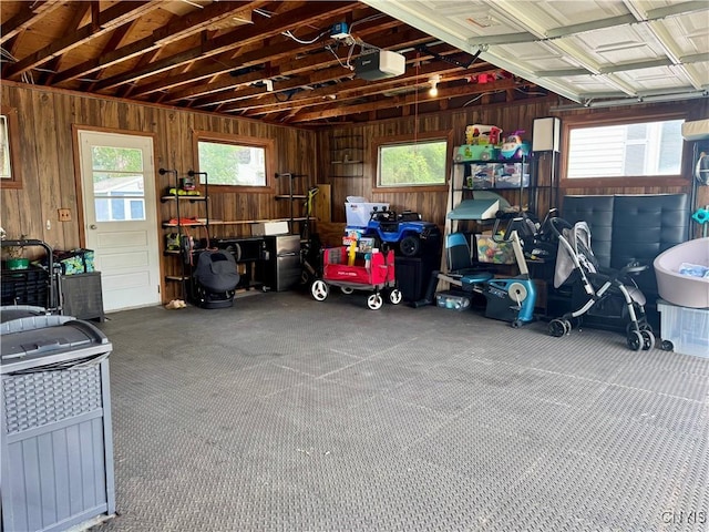 119 Marnie St, Deerfield, NY 13502 - garage featuring a garage door opener and wooden walls