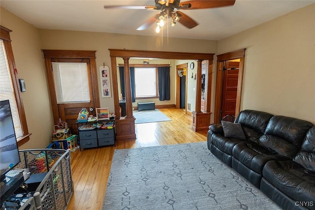 2228-30 Grant Blvd Unit 30, Syracuse, NY 13208 - living room featuring ornate columns, ceiling fan, and light wood-style flooring