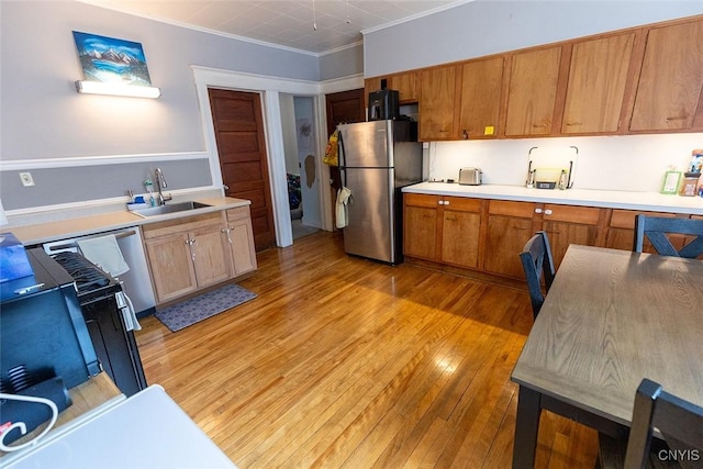 2228-30 Grant Blvd Unit 30, Syracuse, NY 13208 - kitchen featuring freestanding refrigerator, crown molding, light wood finished floors, light countertops, and brown cabinets