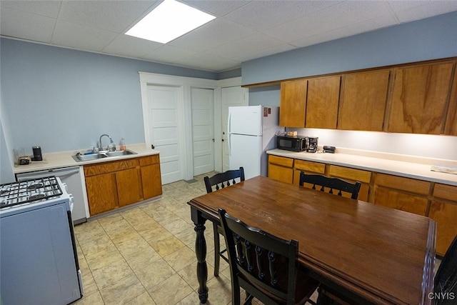 2228-30 Grant Blvd Unit 30, Syracuse, NY 13208 - kitchen with white appliances, brown cabinetry, light countertops, and a drop ceiling