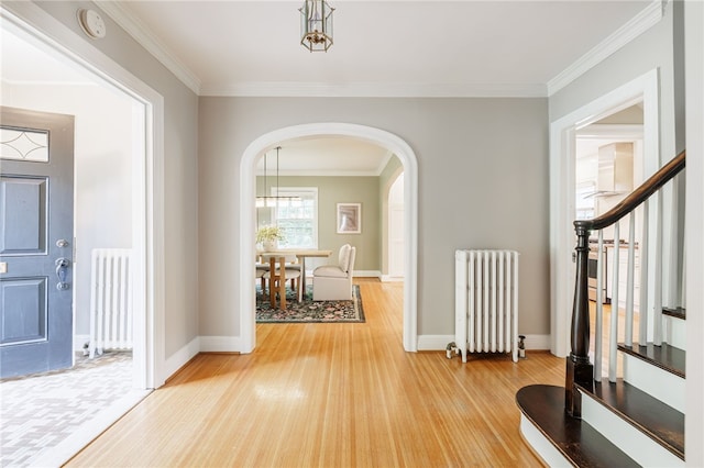 441 Claybourne Rd, Brighton, NY 14618 - foyer entrance with radiator, light wood finished floors, arched walkways, stairway, and ornamental molding