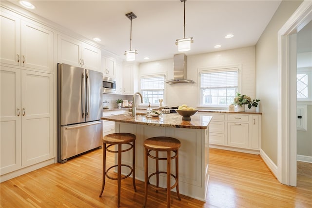 441 Claybourne Rd, Brighton, NY 14618 - kitchen with appliances with stainless steel finishes, range hood, light wood-style floors, white cabinets, and tasteful backsplash