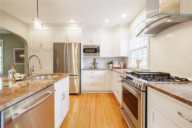 441 Claybourne Rd, Brighton, NY 14618 - kitchen featuring stainless steel appliances, range hood, arched walkways, light wood-style flooring, and white cabinets