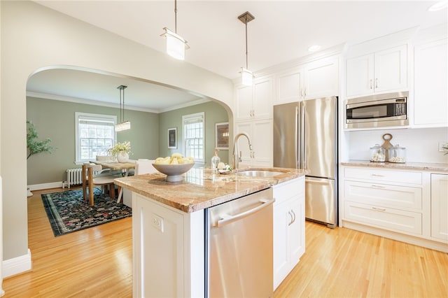 441 Claybourne Rd, Brighton, NY 14618 - kitchen with stainless steel appliances, arched walkways, radiator heating unit, light wood-type flooring, and ornamental molding