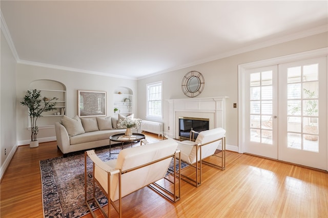 441 Claybourne Rd, Brighton, NY 14618 - living area with radiator, light wood-style floors, a fireplace with flush hearth, built in features, and crown molding