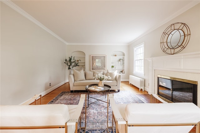 441 Claybourne Rd, Brighton, NY 14618 - living room with radiator, ornamental molding, a glass covered fireplace, wood finished floors, and built in shelves