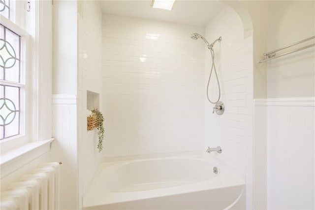 441 Claybourne Rd, Brighton, NY 14618 - full bathroom featuring radiator, wainscoting, and washtub / shower combination