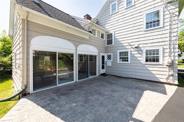 441 Claybourne Rd, Brighton, NY 14618 - rear view of property featuring a patio and a chimney