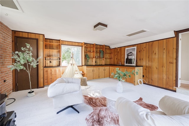 441 Claybourne Rd, Brighton, NY 14618 - living room featuring attic access, wooden walls, carpet floors, and brick wall