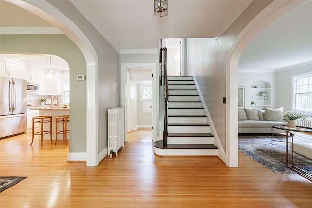 441 Claybourne Rd, Brighton, NY 14618 - stairway with wood finished floors, radiator heating unit, crown molding, and built in features