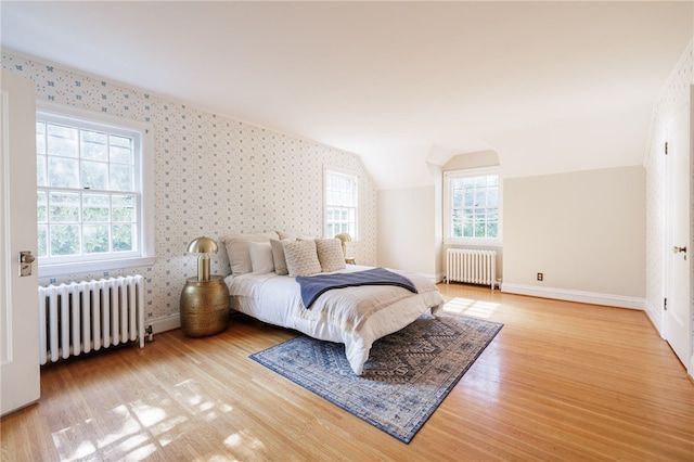 441 Claybourne Rd, Brighton, NY 14618 - bedroom with radiator heating unit, wallpapered walls, wood finished floors, multiple windows, and lofted ceiling