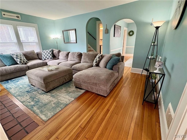 153 Milnor Ave, Syracuse, NY 13224 - living room featuring arched walkways, hardwood / wood-style floors, and stairs