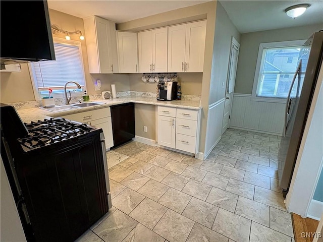 153 Milnor Ave, Syracuse, NY 13224 - kitchen featuring gas stove, dishwasher, freestanding refrigerator, wainscoting, and white cabinetry
