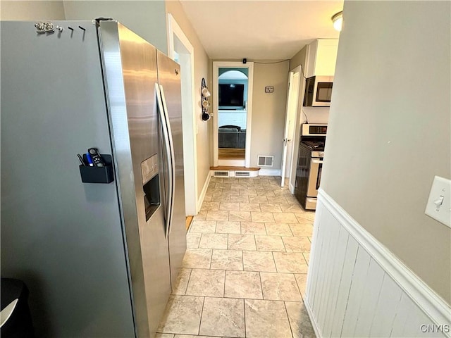 153 Milnor Ave, Syracuse, NY 13224 - kitchen with appliances with stainless steel finishes, white cabinetry, and light stone finish flooring