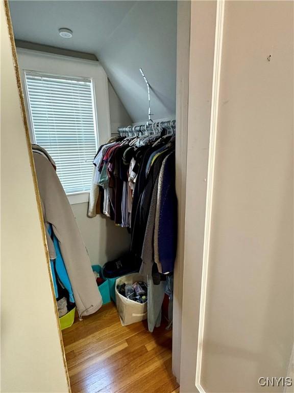 153 Milnor Ave, Syracuse, NY 13224 - walk in closet featuring wood finished floors and vaulted ceiling