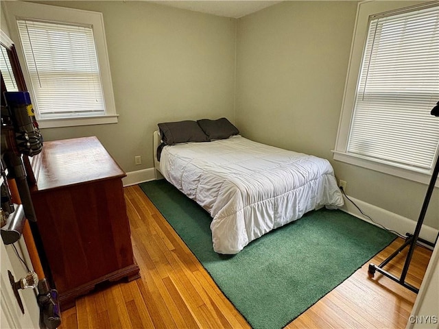 153 Milnor Ave, Syracuse, NY 13224 - bedroom featuring wood finished floors and multiple windows