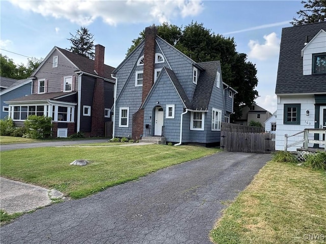 153 Milnor Ave, Syracuse, NY 13224 - view of front of home with roof with shingles, a chimney, and driveway