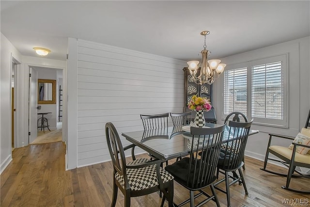 72 Old Lyme Dr Unit 3, Amherst, NY 14221 - dining room with wood finished floors and a chandelier