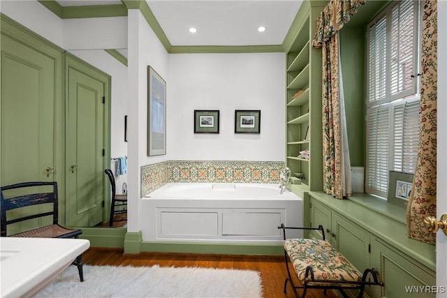 107 Oakland Pl Unit 1, Buffalo, NY 14222 - bathroom featuring wood finished floors, a garden tub, plenty of natural light, and recessed lighting